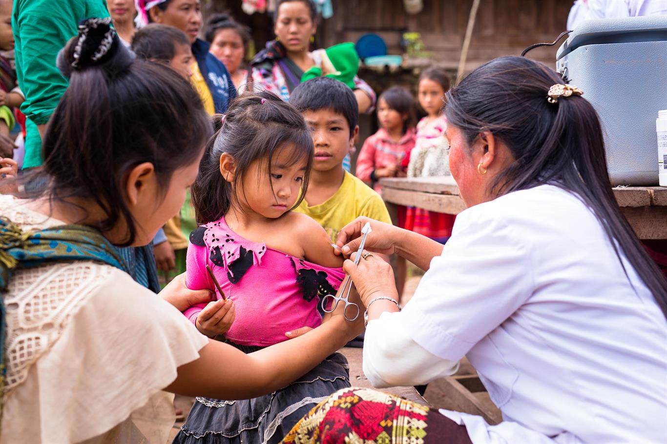 A girl gets vaccinated against measles.